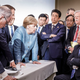 German Chancellor Angela Merkel deliberates with President Donald Trump on the sidelines of the official agenda on the second day of the G-7 summit June 9, 2018, in Charlevoix, Canada. Also pictured are (from left) Larry Kudlow, director of the U.S. National Economic Council; Theresa May, U.K. prime minister; Emmanuel Macron, French president; Merkel; Yasutoshi Nishimura, Japanese deputy chief Cabinet secretary; Shinzō Abe, Japan prime minister; Kazuyuki Yamazaki, Japanese senior deputy minister for foreign affairs; John Bolton, U.S. national security adviser; and Trump.